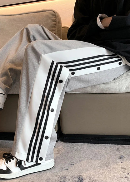 Side view of snap button black pants – unisex design